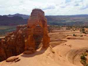 The Delicate Arch with the canyons in the background