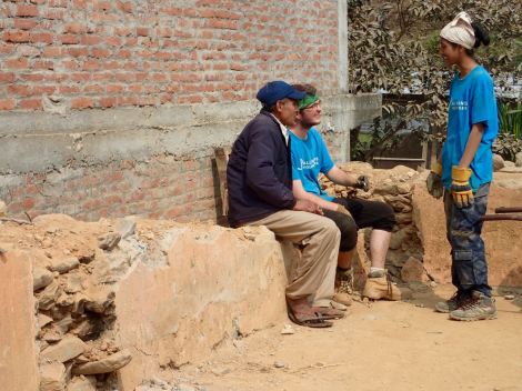 Potter bonding with one of the men in the community with Mamata translating
